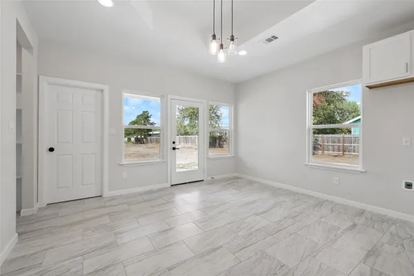 a view of a kitchen with kitchen island a sink stainless steel appliances and cabinets