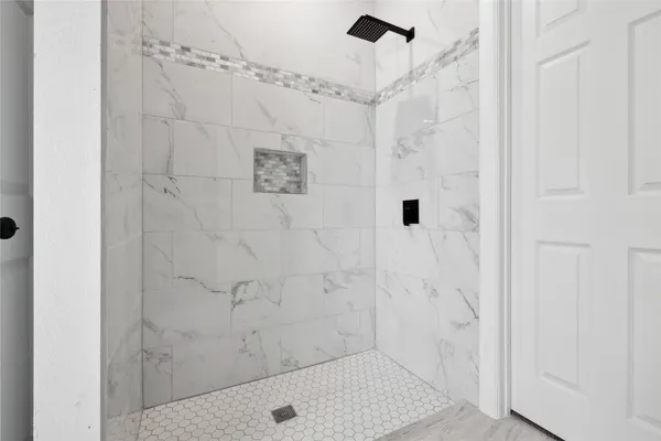 a bathroom with a sink a toilet and a shower