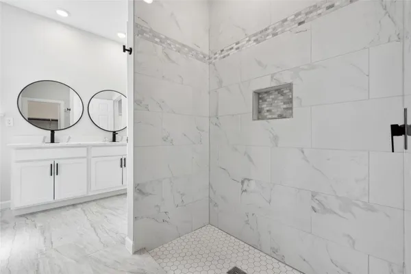 a bathroom with a glass shower door