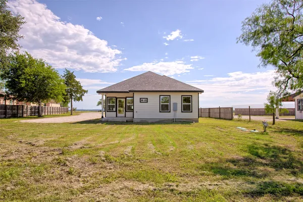 a house view with swimming pool in front of it