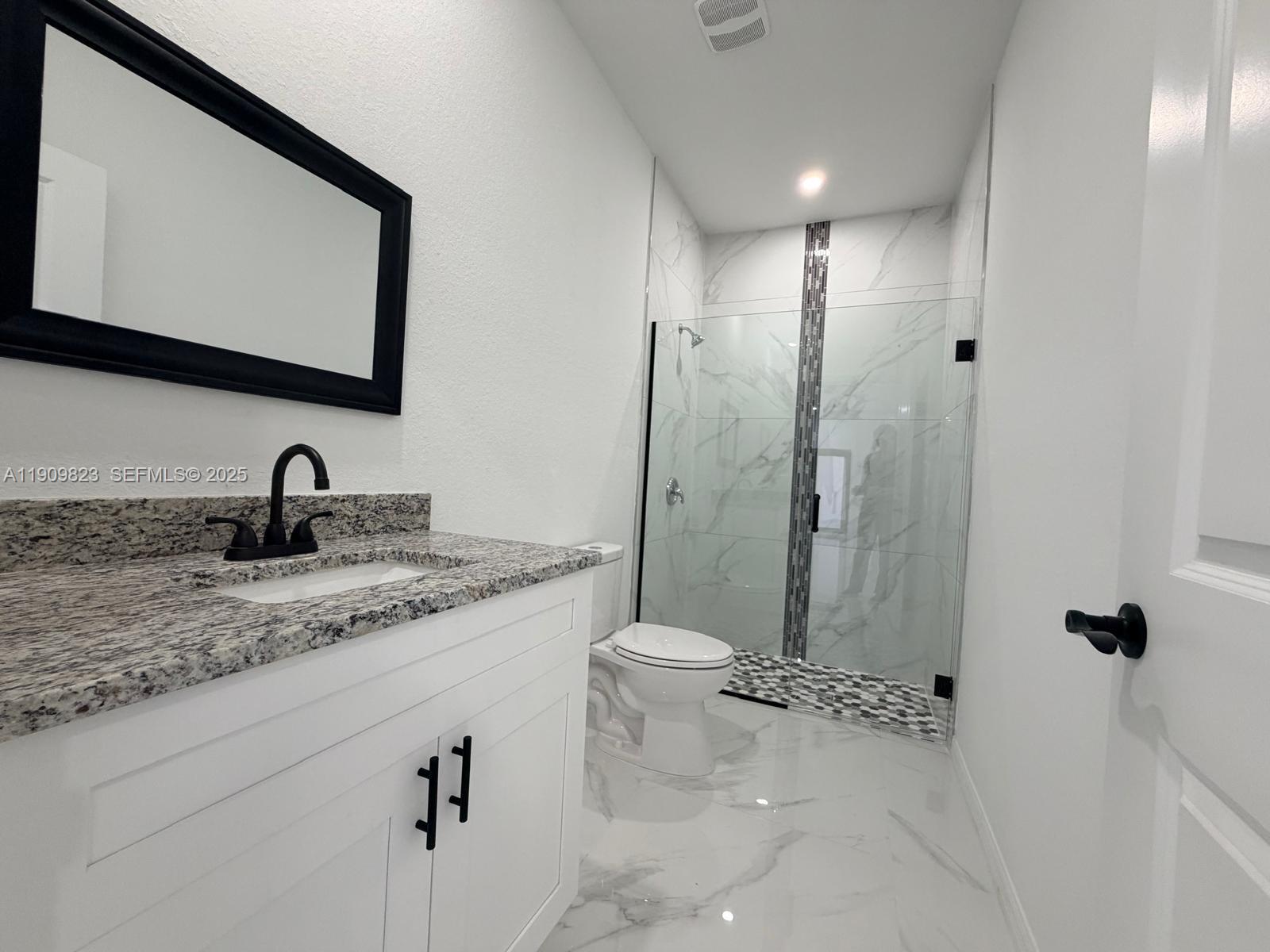 2706 72nd Street West Lehigh Acres, FL 33971 - Photo 14 of 21 a bathroom with a double vanity sink and a mirror