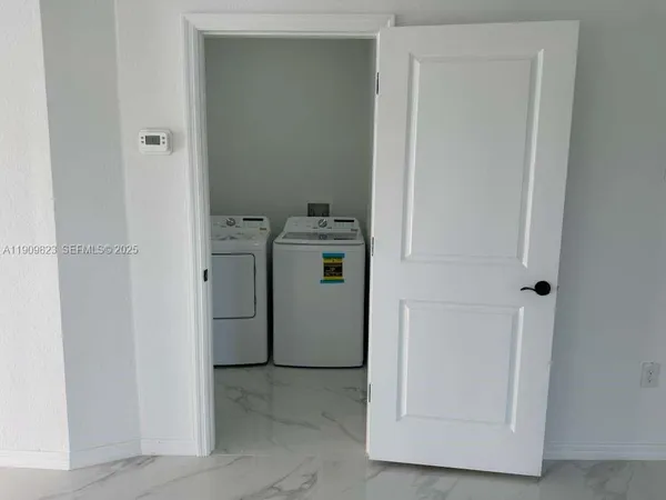 a utility room with dryer and washer