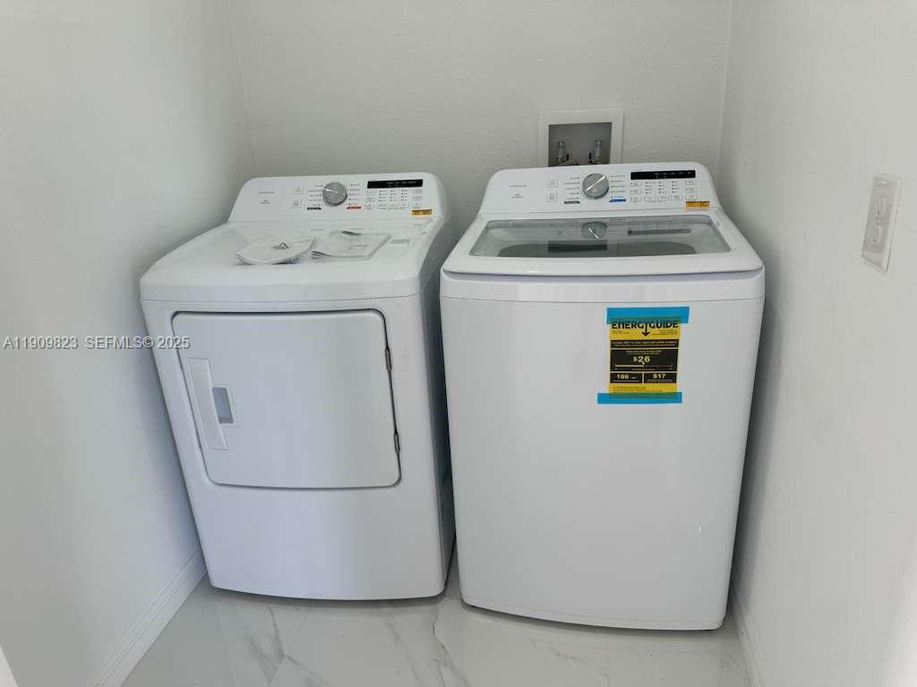 2706 72nd Street West Lehigh Acres, FL 33971 - Photo 19 of 21 a utility room with dryer and washer