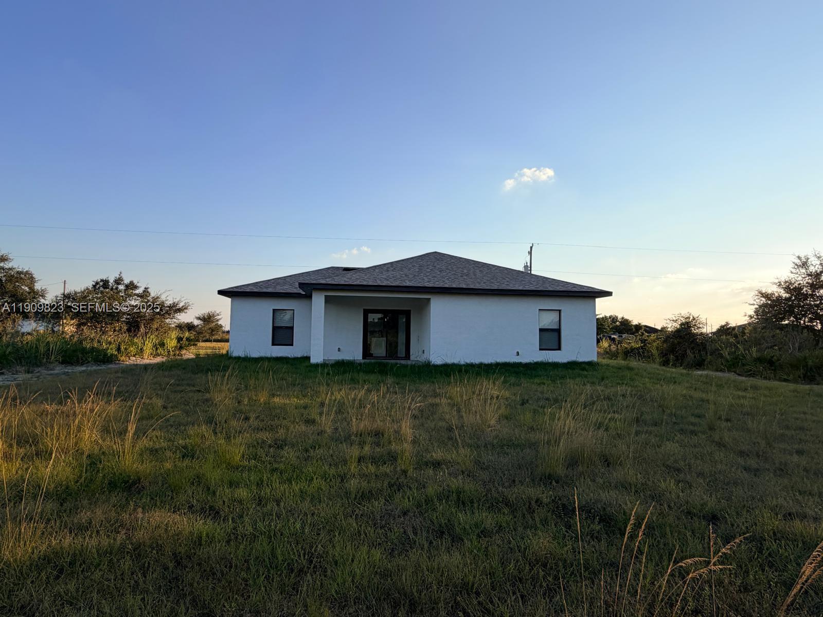 2706 72nd Street West Lehigh Acres, FL 33971 - Photo 20 of 21 a view of a house with a yard