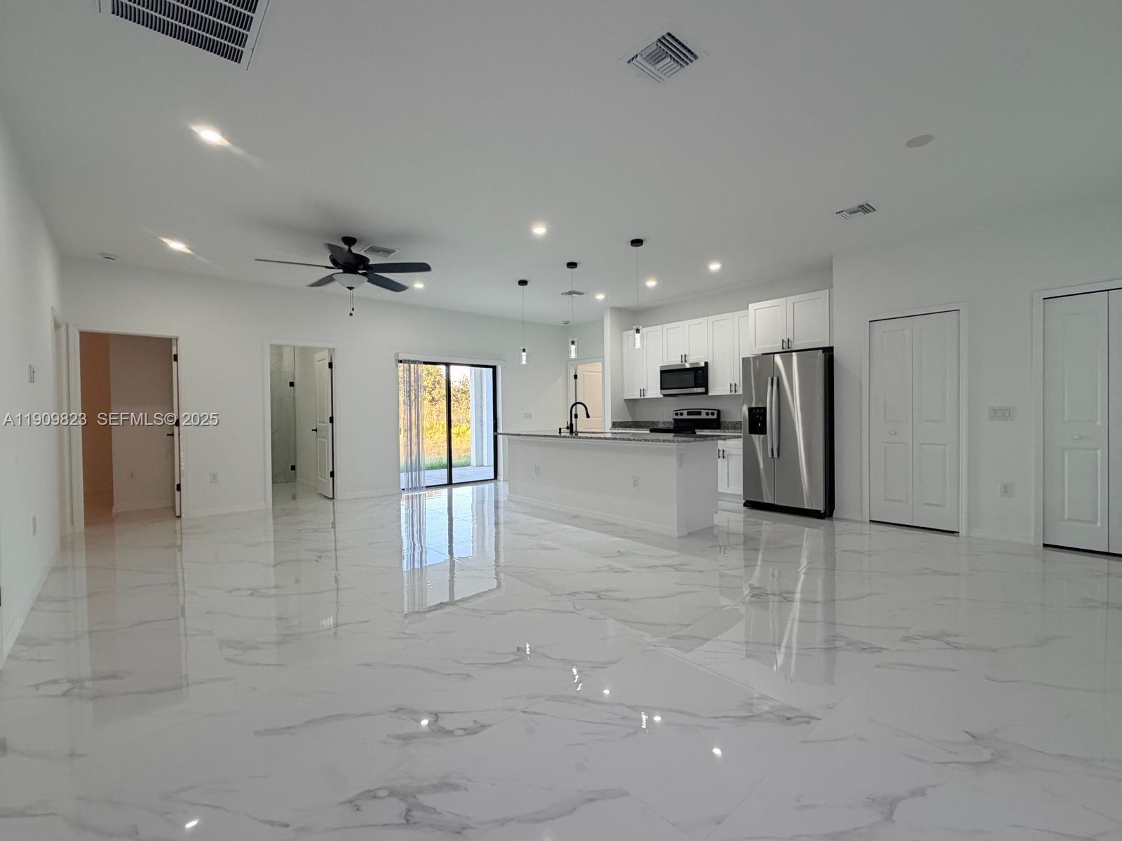 2706 72nd Street West Lehigh Acres, FL 33971 - Photo 2 of 21 a view of a hallway with stainless steel appliances