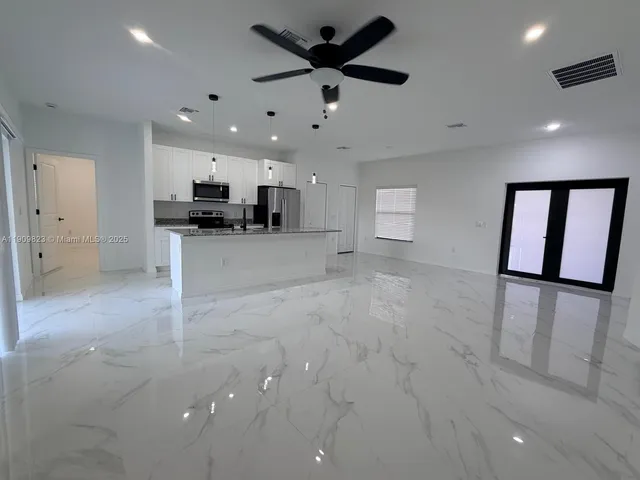a view of a kitchen with a sink and a refrigerator