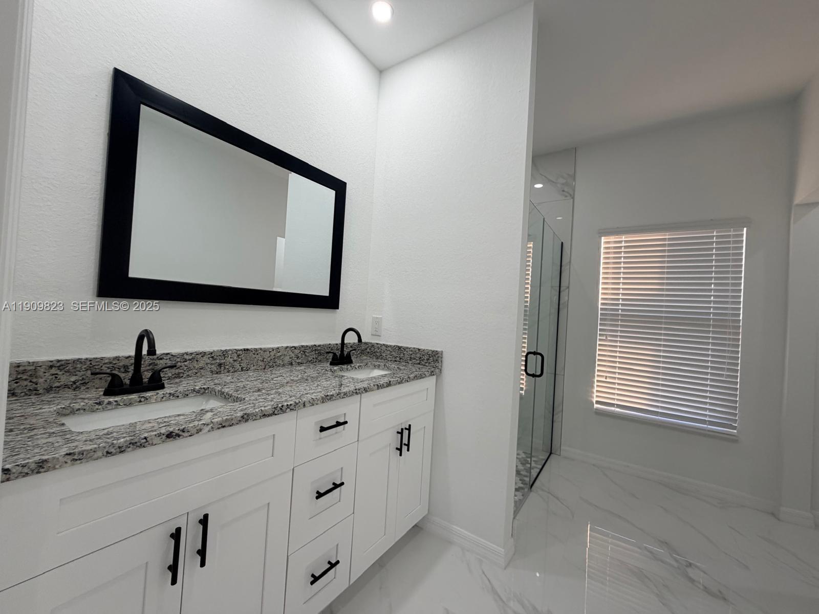 2706 72nd Street West Lehigh Acres, FL 33971 - Photo 8 of 21 a bathroom with double sink and a mirror