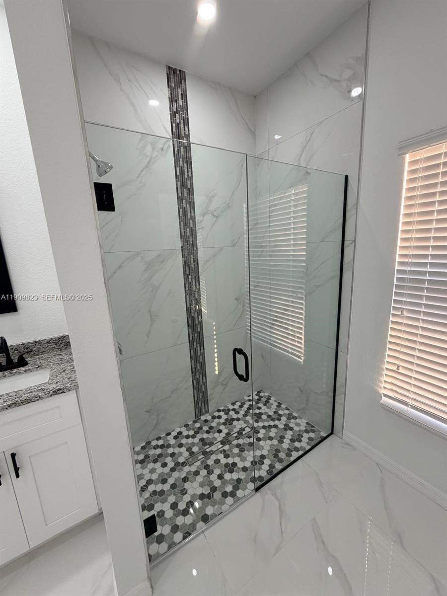 2706 72nd Street West Lehigh Acres, FL 33971 - Photo 9 of 21 a bathroom with a granite countertop shower and a sink