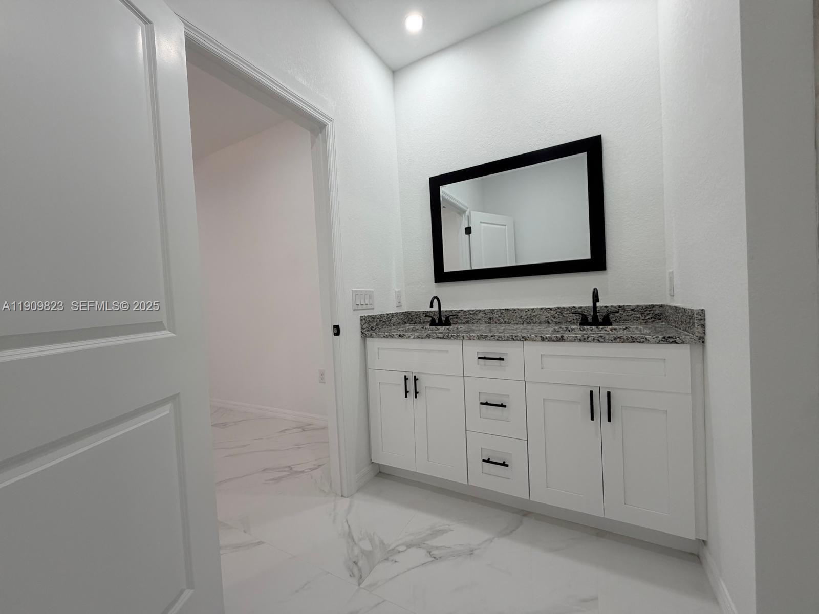 2706 72nd Street West Lehigh Acres, FL 33971 - Photo 10 of 21 a bathroom with granite countertop double vanity sink and mirror