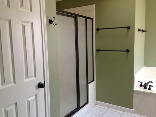 a bathroom with a shower and a glass door
