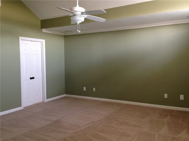 an empty room with a fan
