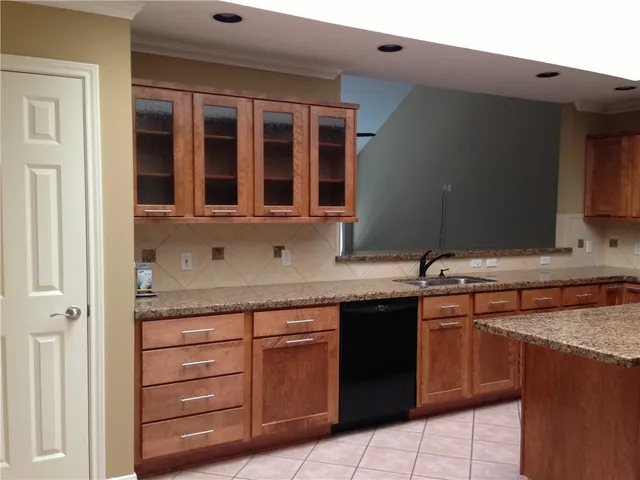 a kitchen with a sink and cabinets
