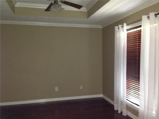 a view of a small space with wooden floor and a window