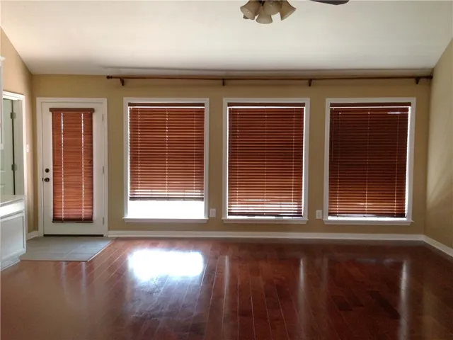 a view of a livingroom with wooden floor and window