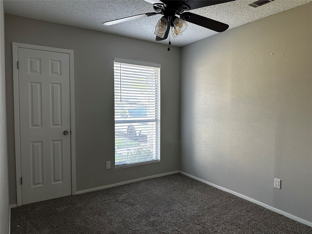 504 Suzzane Road Pflugerville, TX 78660 - Photo 7 of 15 an empty room with windows and fan