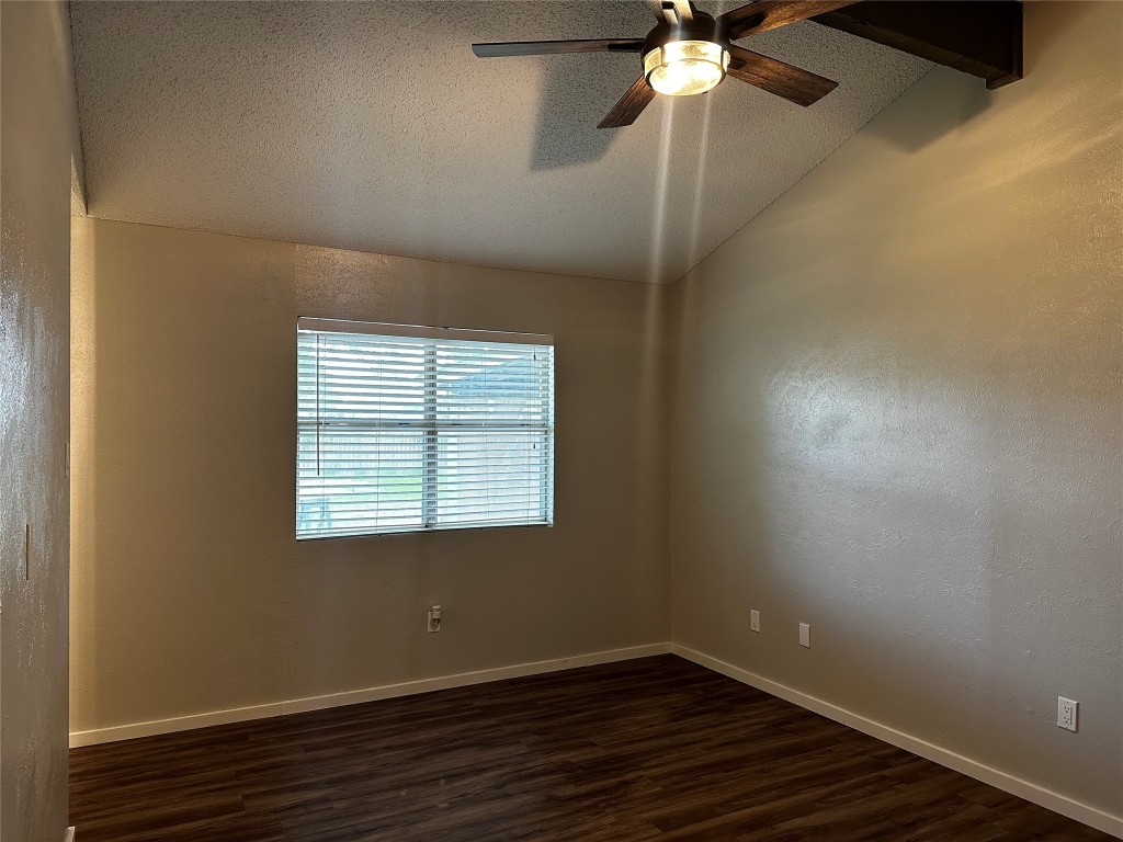 504 Suzzane Road Pflugerville, TX 78660 - Photo 10 of 15 an empty room with wooden floor fan and windows