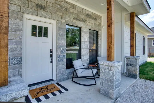 a building outdoor space with patio furniture and potted plants
