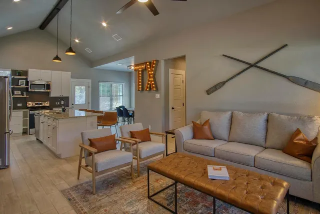 a living room with furniture and kitchen view