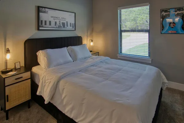 a bedroom with a bed and a night stand