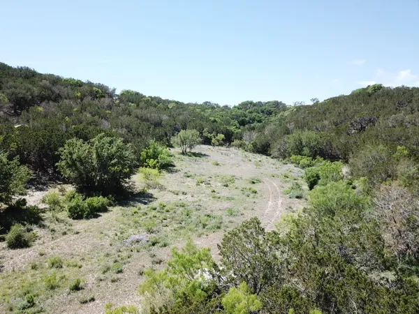 a view of a large building with mountains in the background