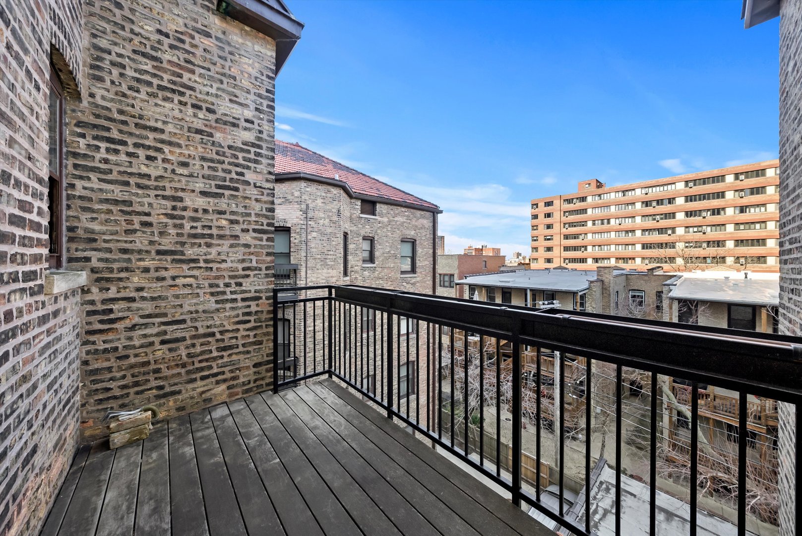 666 West Irving Park Road, Unit I4 Chicago, IL 60613 - Photo 12 of 27 a view of a balcony with wooden floor and fence