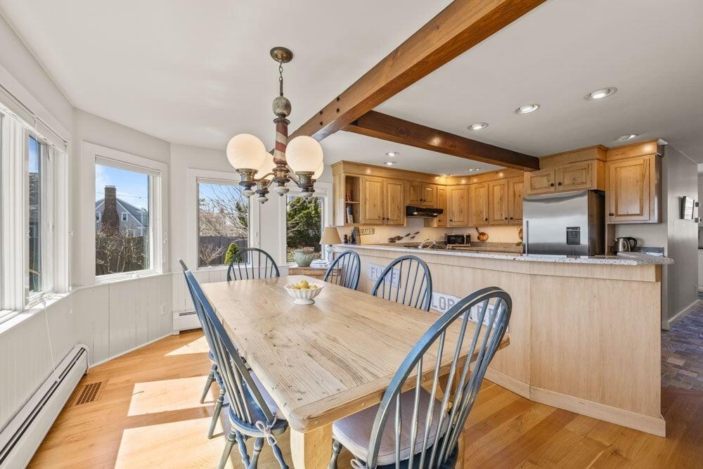 8 Wyndemere Bluffs Road Harwich Port, MA 02646 - Photo 13 of 37 a dining room filled chandelier and wooden floor