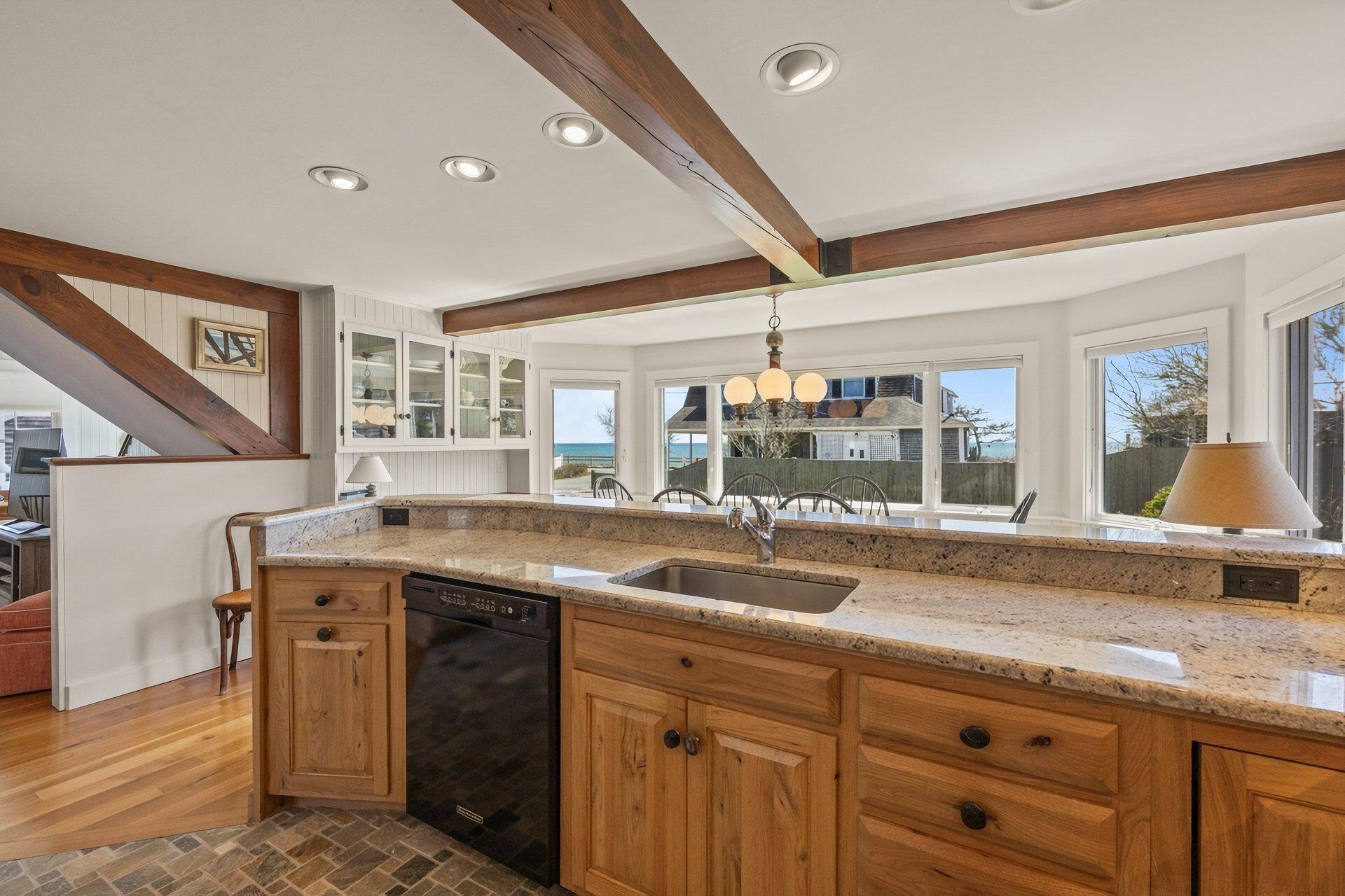 8 Wyndemere Bluffs Road Harwich Port, MA 02646 - Photo 15 of 37 a kitchen with a sink and wooden cabinets