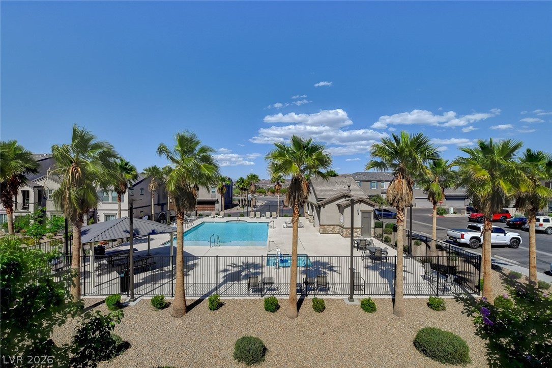 484 Filaree Place Henderson, NV 89015 - Photo 3 of 71 Enjoy leisurely days by the sparkling community pool, surrounded by lush palms and inviting lounge areas.
