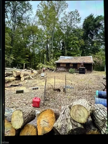 a view of swimming pool with lounge chair and trees