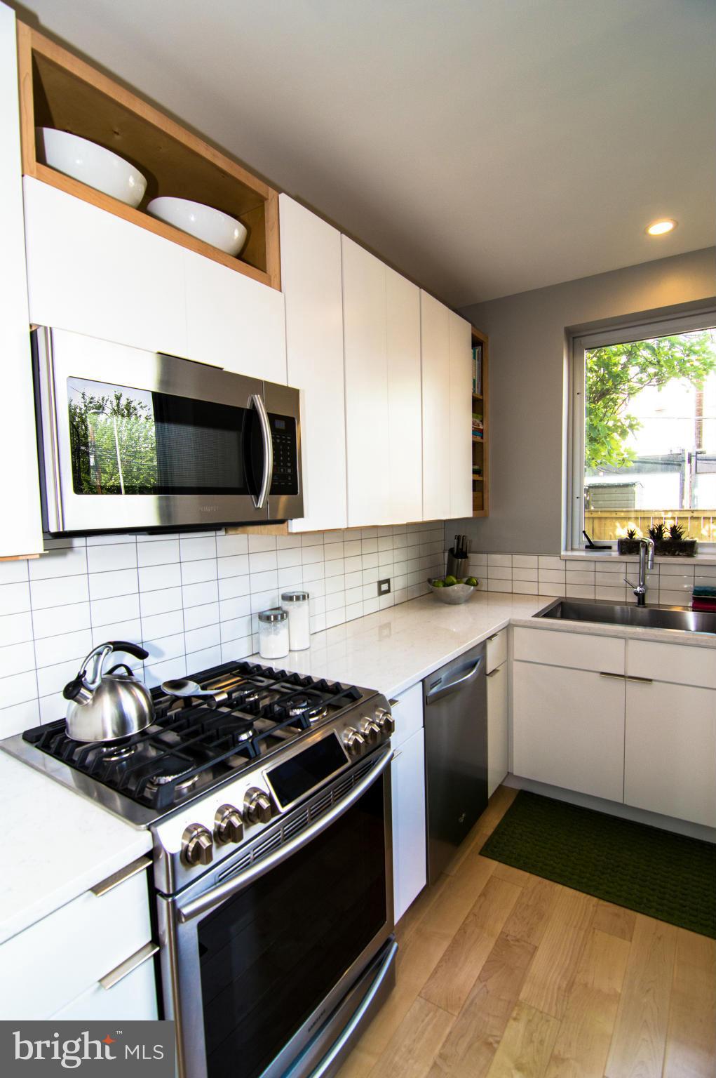 606 14th Place Northeast Washington, DC 20002 - Photo 11 of 28 a kitchen with stainless steel appliances a sink a stove and microwave