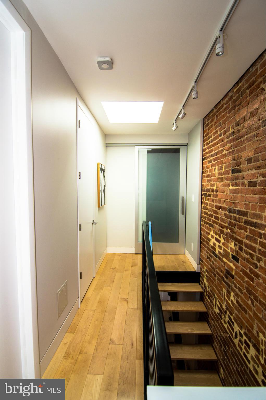606 14th Place Northeast Washington, DC 20002 - Photo 17 of 28 a view of a hallway with wooden floor and a bathroom