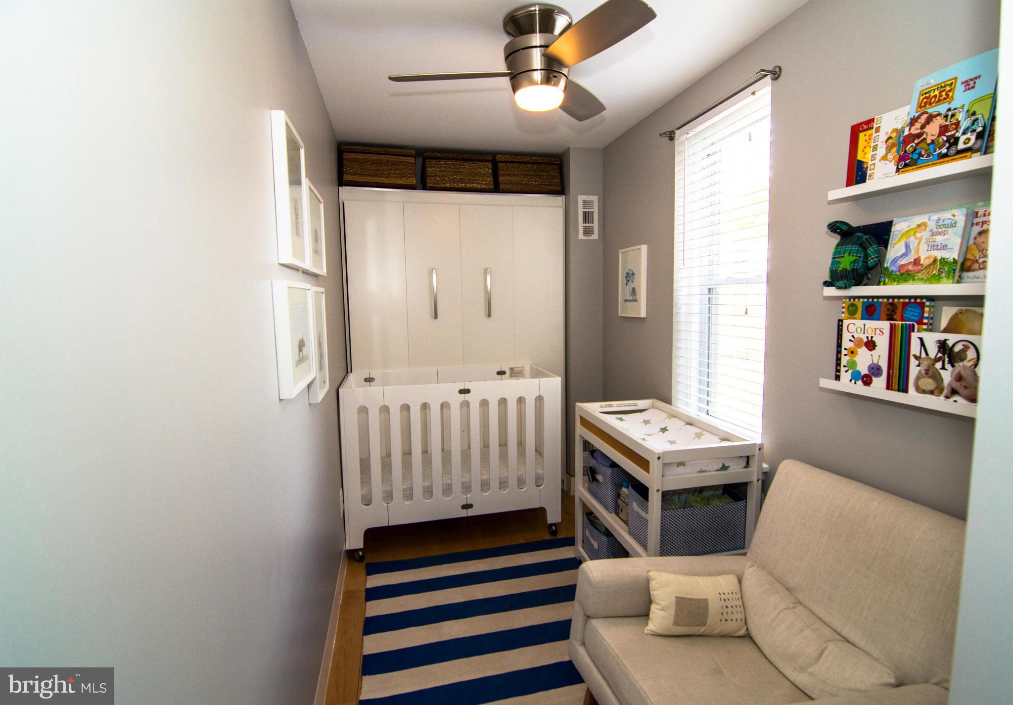606 14th Place Northeast Washington, DC 20002 - Photo 22 of 28 a living room with furniture and a baby crib