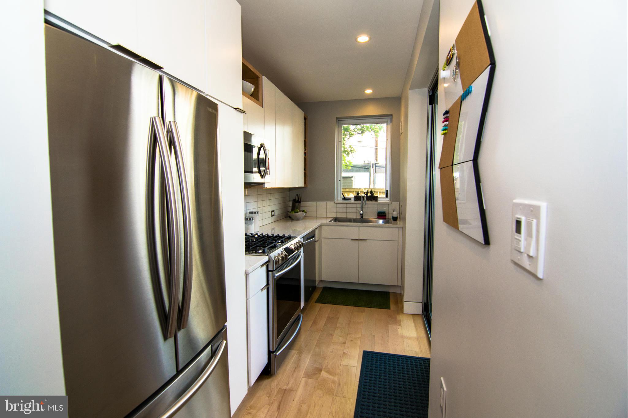 606 14th Place Northeast Washington, DC 20002 - Photo 10 of 28 a kitchen with stainless steel appliances granite countertop a refrigerator a stove and a sink
