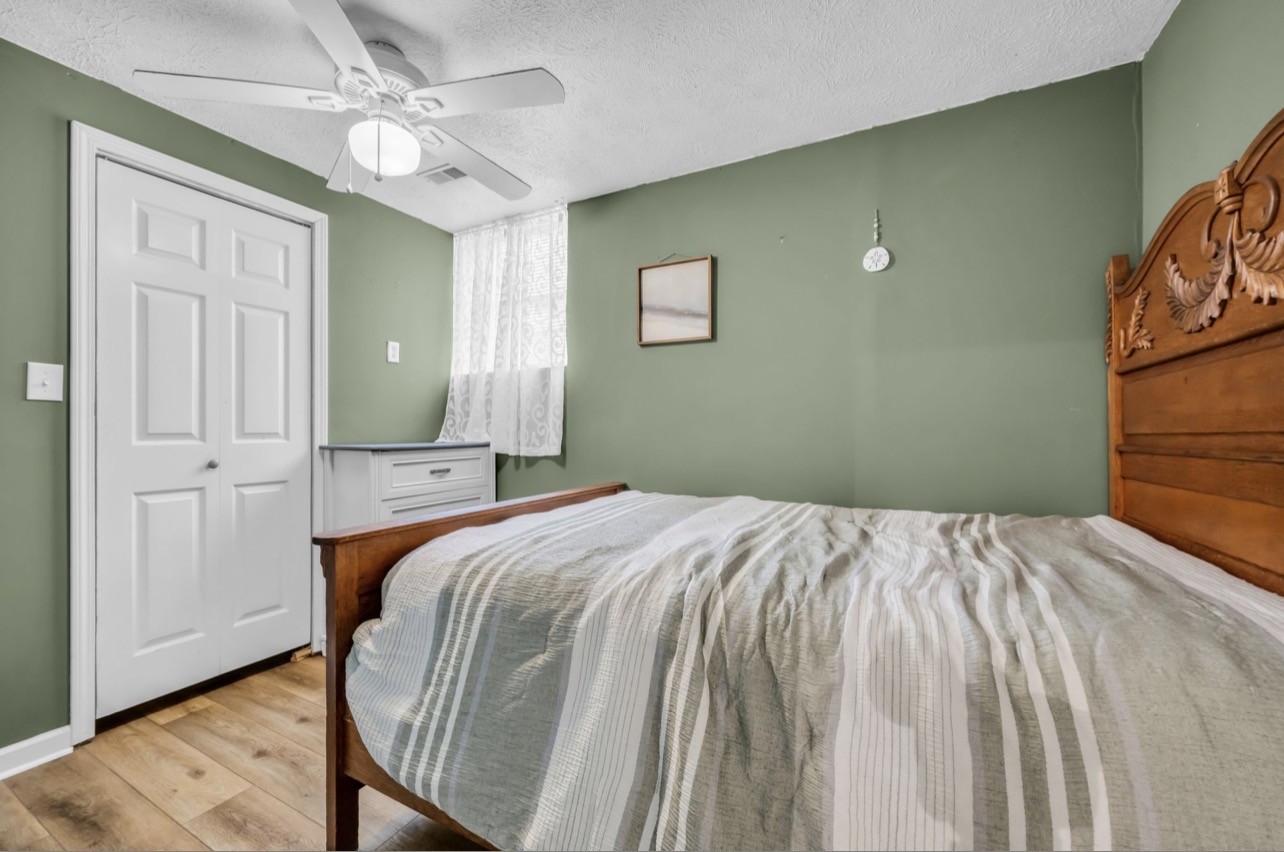 1051 Twin Pine Road Dickson, TN 37055 - Photo 16 of 29 a bedroom with a bed and wooden floor