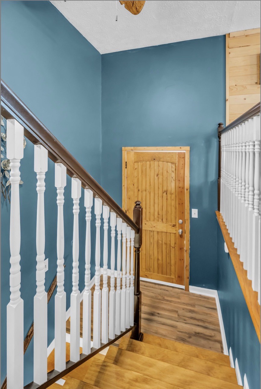 1051 Twin Pine Road Dickson, TN 37055 - Photo 20 of 29 a view of a hallway with wooden floor and staircase