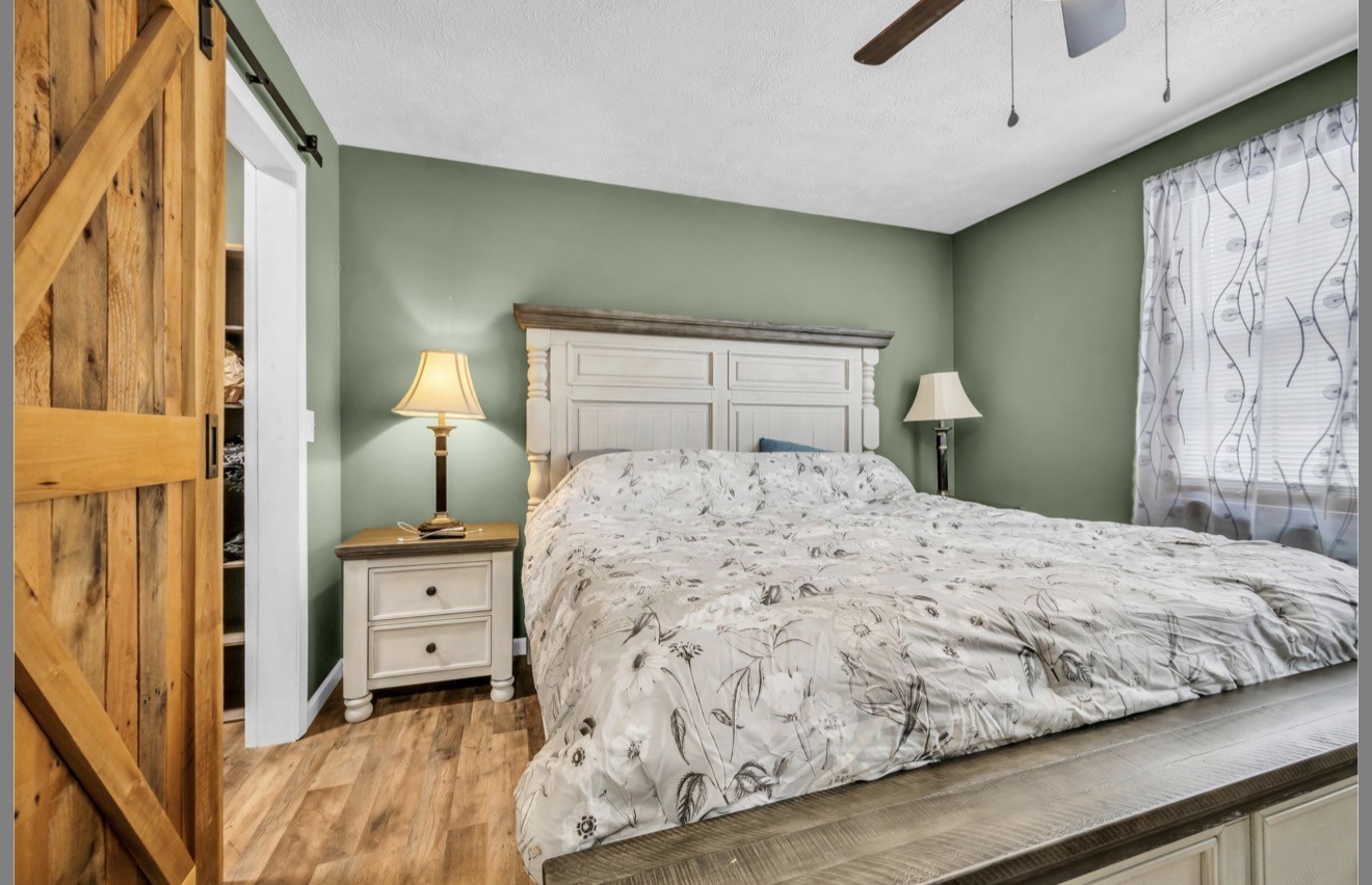 1051 Twin Pine Road Dickson, TN 37055 - Photo 21 of 29 a bedroom with a bed and a painting on the wall