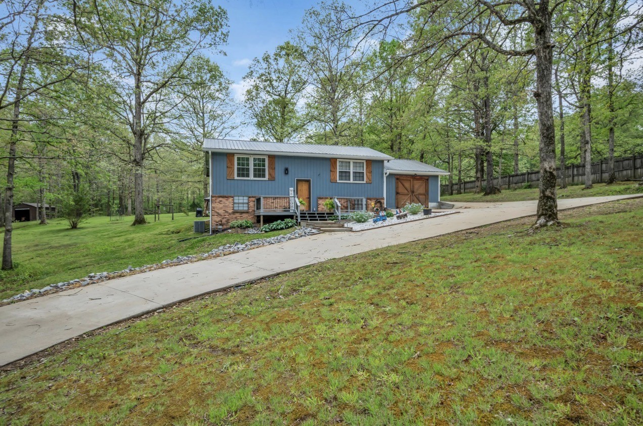 1051 Twin Pine Road Dickson, TN 37055 - Photo 4 of 29 a front view of a house with garden