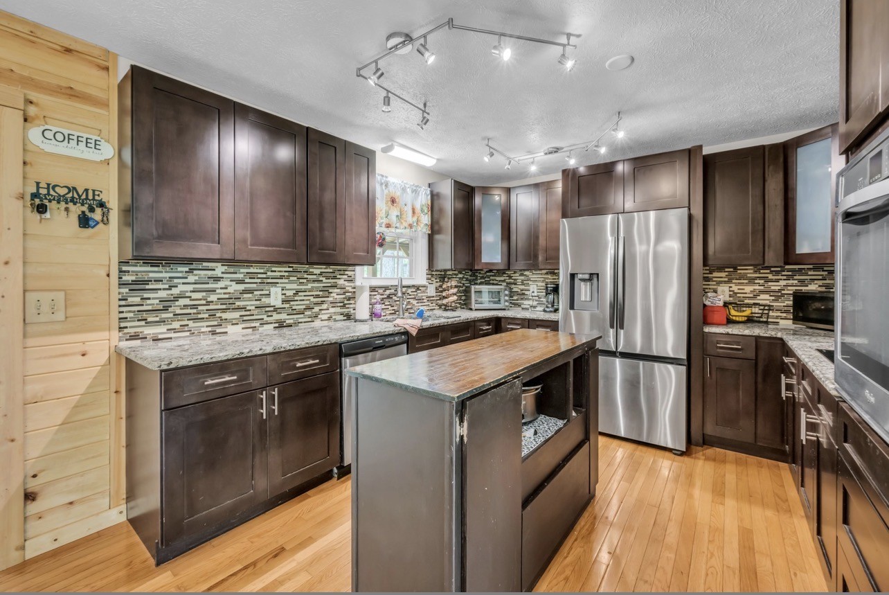 1051 Twin Pine Road Dickson, TN 37055 - Photo 9 of 29 a kitchen with stainless steel appliances granite countertop a refrigerator a stove a sink dishwasher and a refrigerator with wooden floor