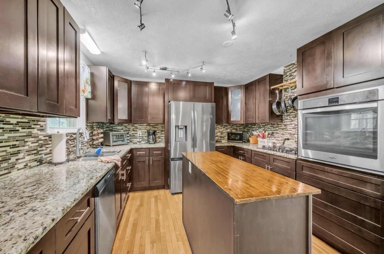 1051 Twin Pine Road Dickson, TN 37055 - Photo 10 of 29 a kitchen with stainless steel appliances granite countertop a sink stove microwave and refrigerator
