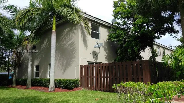 a view of a wooden fence next to a yard