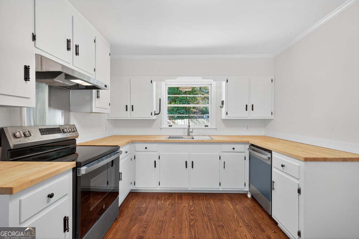 352 3rd Avenue Winder, GA 30680 - Photo 12 of 33 a kitchen with granite countertop white cabinets and white appliances