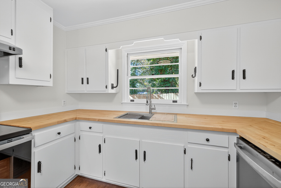 352 3rd Avenue Winder, GA 30680 - Photo 14 of 33 a kitchen with white cabinets and a sink
