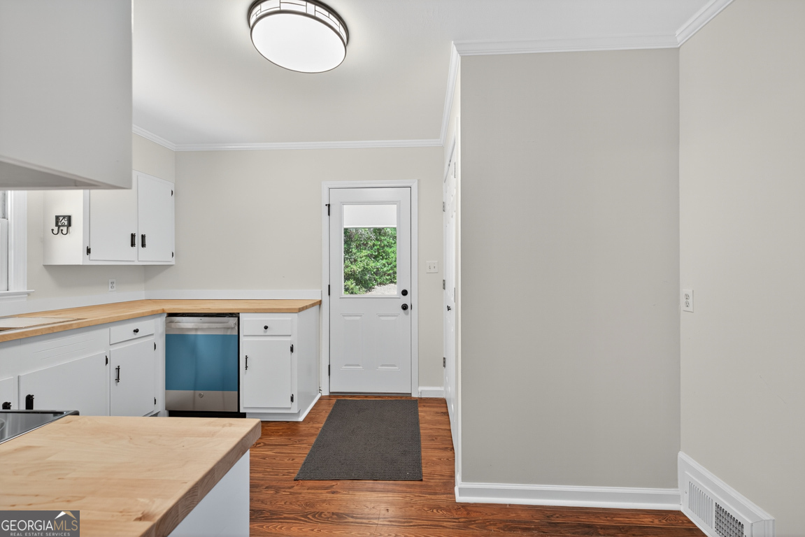 352 3rd Avenue Winder, GA 30680 - Photo 16 of 33 a kitchen with cabinets and wooden floor