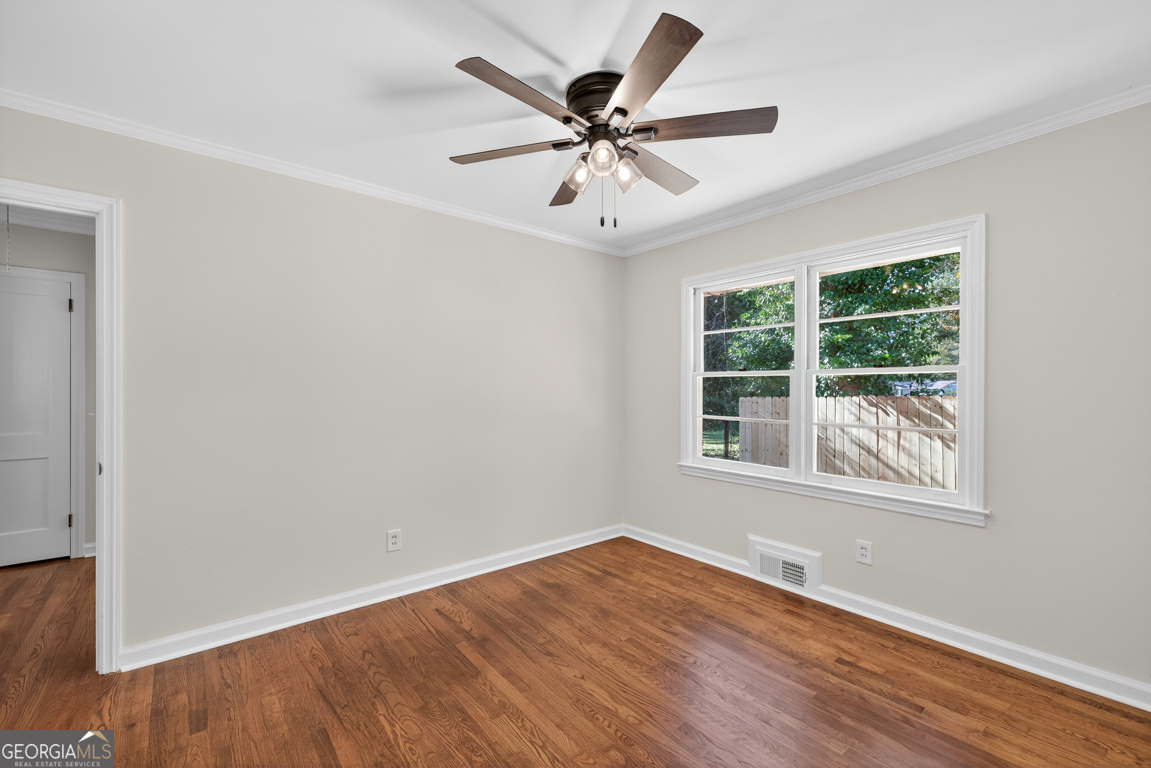 352 3rd Avenue Winder, GA 30680 - Photo 17 of 33 an empty room with wooden floor fan and windows