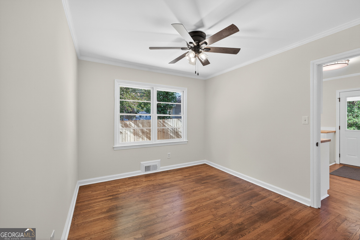 352 3rd Avenue Winder, GA 30680 - Photo 18 of 33 an empty room with wooden floor fan and windows