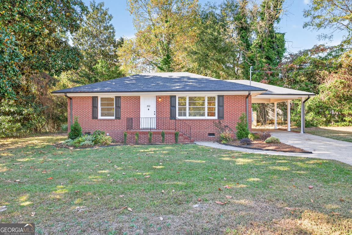 352 3rd Avenue Winder, GA 30680 - Photo 2 of 33 a front view of a house with a yard and trees