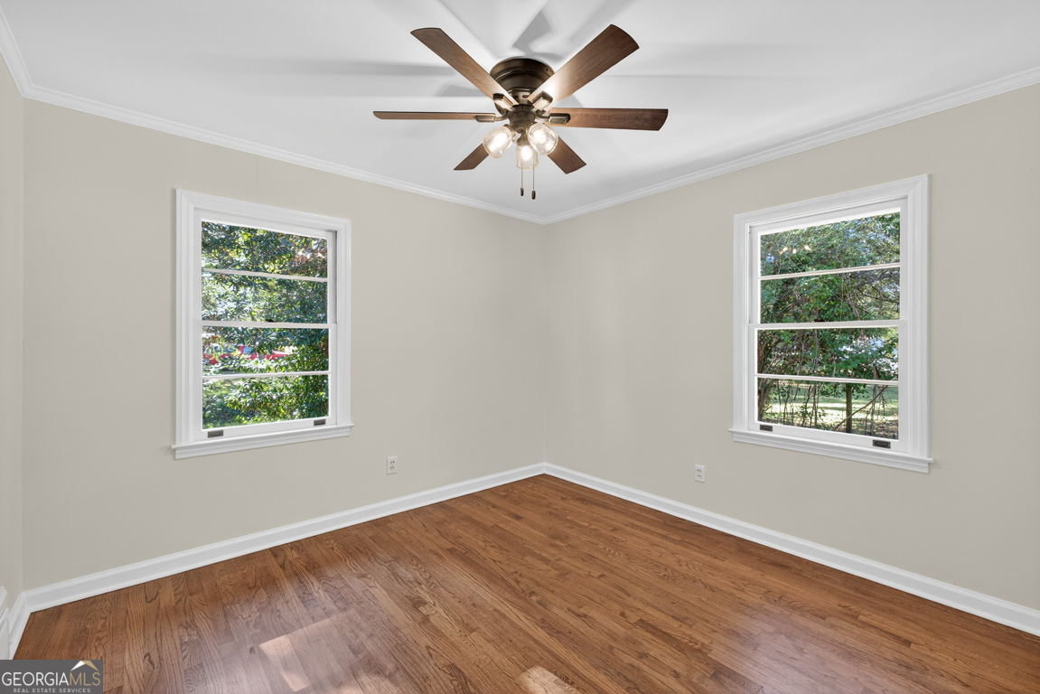 352 3rd Avenue Winder, GA 30680 - Photo 24 of 33 a view of an empty room with wooden floor and a window