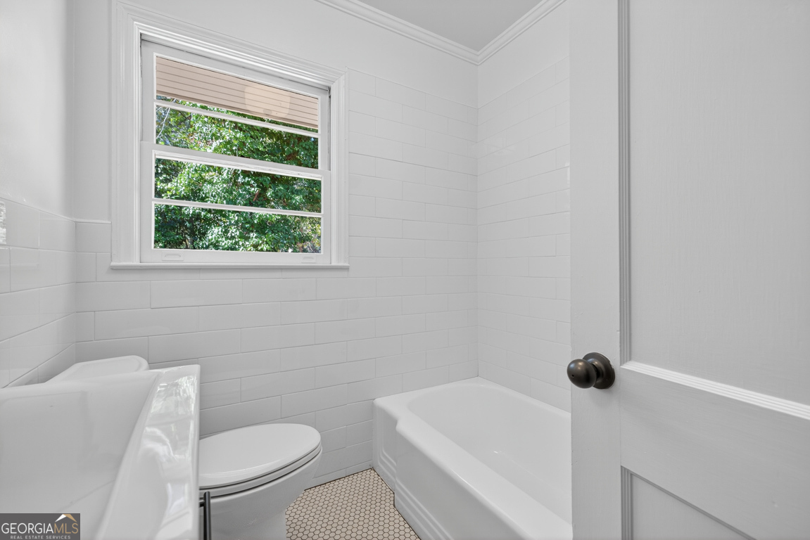 352 3rd Avenue Winder, GA 30680 - Photo 28 of 33 a bathroom with a toilet a sink a window and shower
