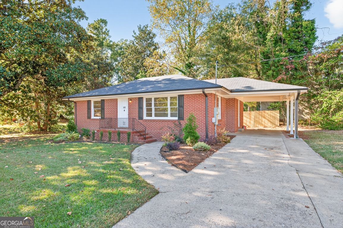 352 3rd Avenue Winder, GA 30680 - Photo 3 of 33 a front view of a house with a yard and potted plants