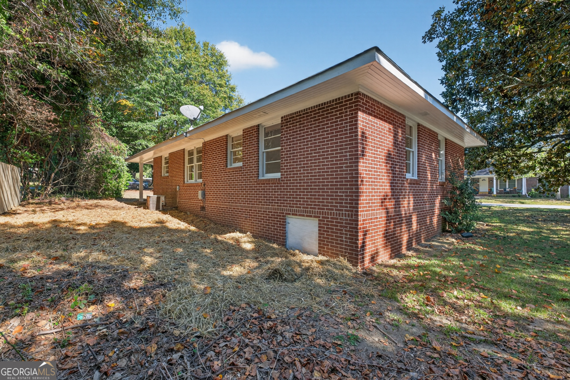 352 3rd Avenue Winder, GA 30680 - Photo 32 of 33 a backyard of a house with large trees